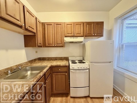A kitchen with wooden cabinets and a white stove.