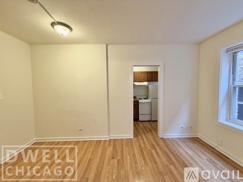 A spacious room with tiled flooring and white walls.