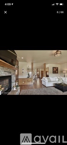 A modern living room with a fireplace and a large painting on the wall.