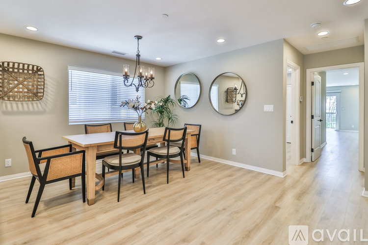 A dining room with a wooden table and chairs.