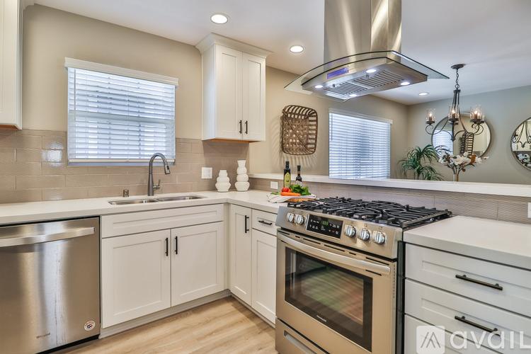 A modern kitchen with a stainless steel dishwasher and oven.
