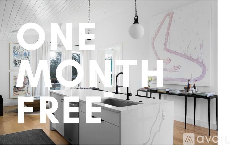 A kitchen with a large painting on the wall and a text that says "ONE MONTH FREE".
