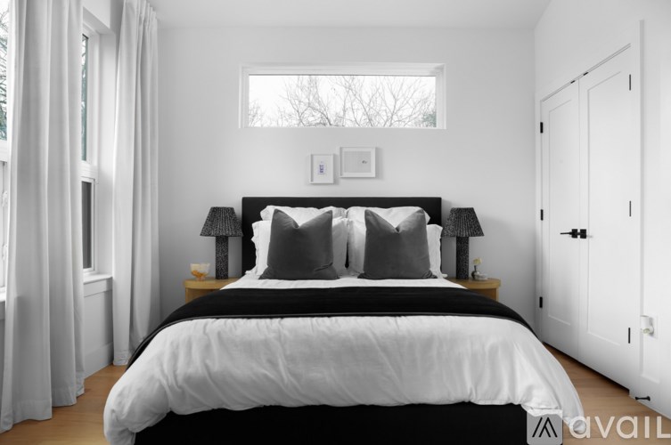 A bedroom with a large bed and a window.