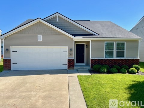 A house with a grey roof and a white garage door.