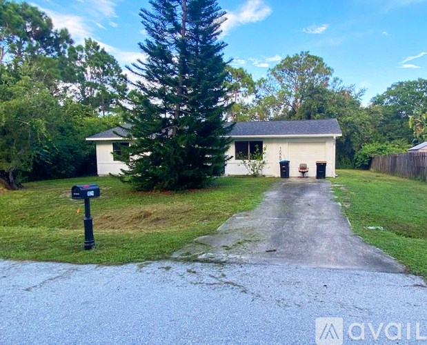A house with a driveway and a mailbox in front of it.