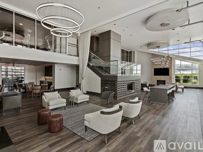 A modern living room with a spiral staircase and a fireplace.