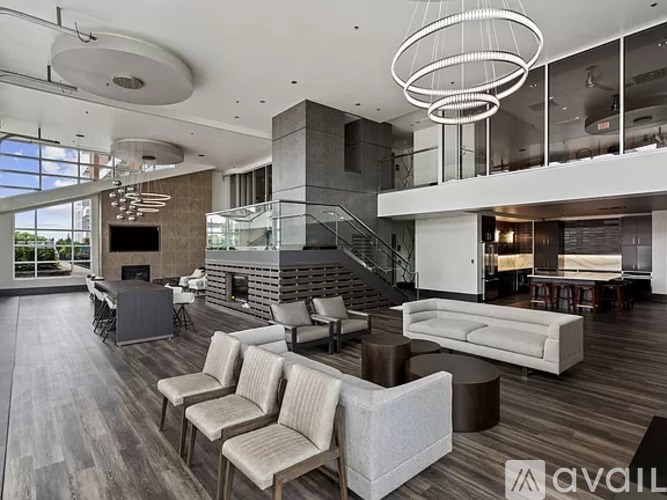 A living room with a fireplace and a staircase.