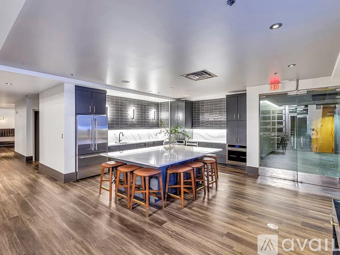 A kitchen with a bar stool and a counter.