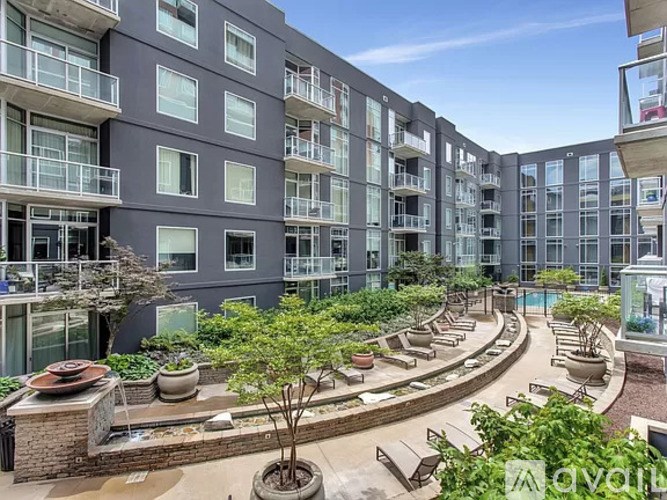 Apartment complex with a courtyard and a pool.