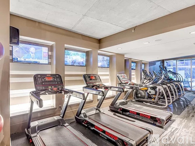 A gym with treadmills and elliptical machines.