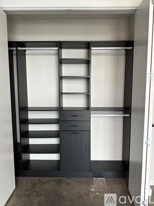 A black and white wardrobe with shelves and drawers.