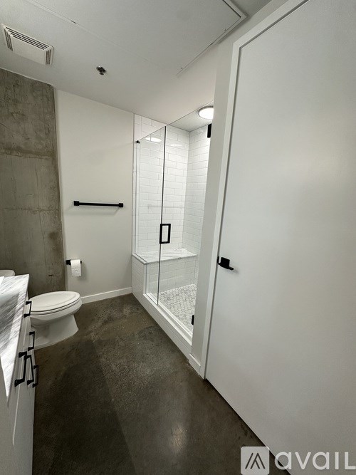 A bathroom with a toilet, sink, and shower.