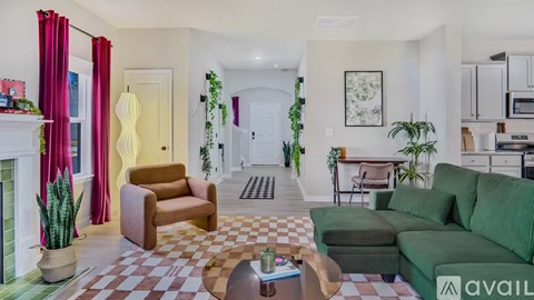 A living room with a green couch and a brown armchair.