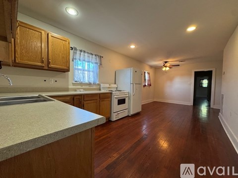 A kitchen with wooden cabinets and a white refrigerator.