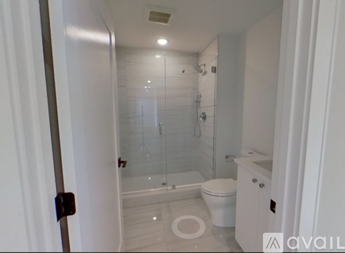 A bathroom with a toilet, sink, and shower.