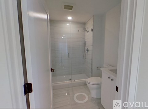 A bathroom with a toilet, sink, and shower.