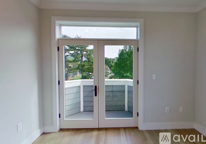 A room with a sliding glass door leading to a balcony.