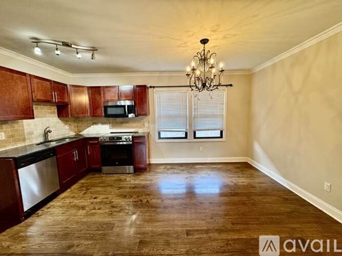 A kitchen with wooden cabinets and a black countertop.