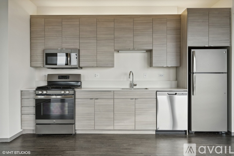 A modern kitchen with a stainless steel oven and refrigerator.