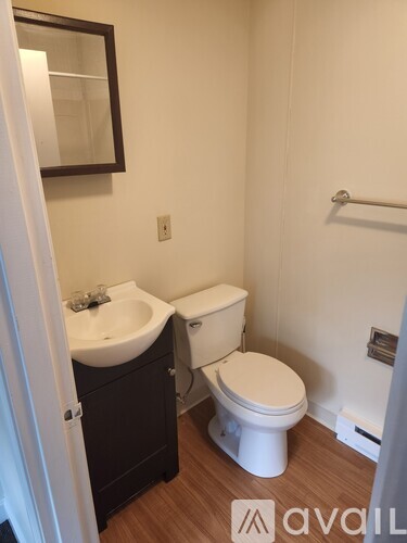 A white toilet sits next to a sink in a small bathroom.