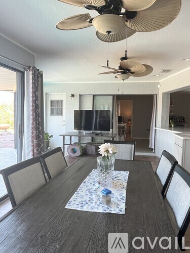 A dining room with a table set for four.