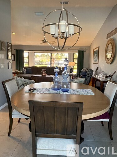 A dining room with a round table and chairs.