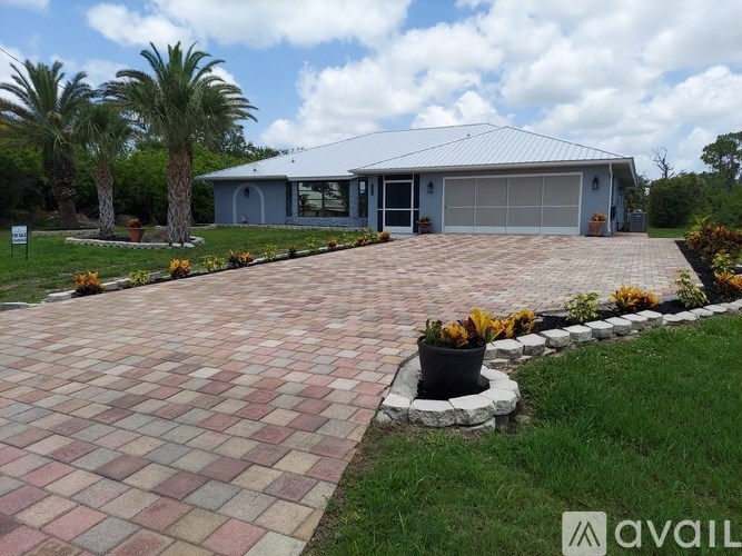A house with a garage and a driveway in front.