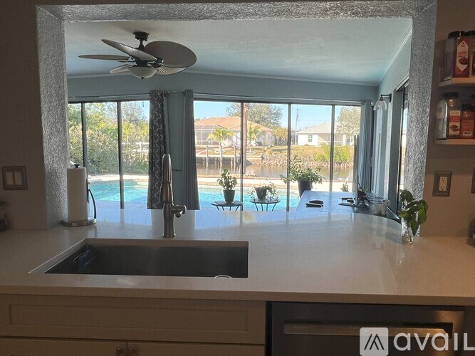A kitchen with a sink and a fan.