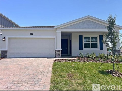 A house with a white garage door and a blue window.