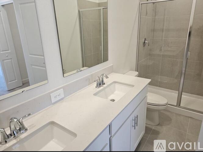 A bathroom with a white sink and a white toilet.