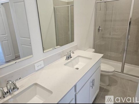 A bathroom with a white sink and a white toilet.