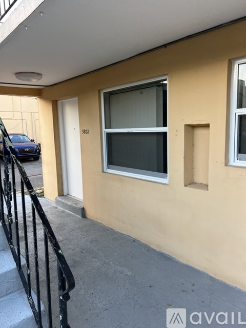 A balcony with a metal railing and a window.