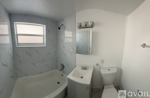 A spacious room with a tiled floor and a ceiling fan.
