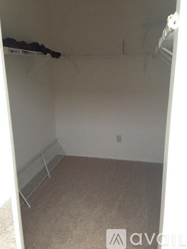 A room with white walls and a carpeted floor.