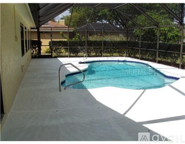 A small pool in a backyard with a metal fence.