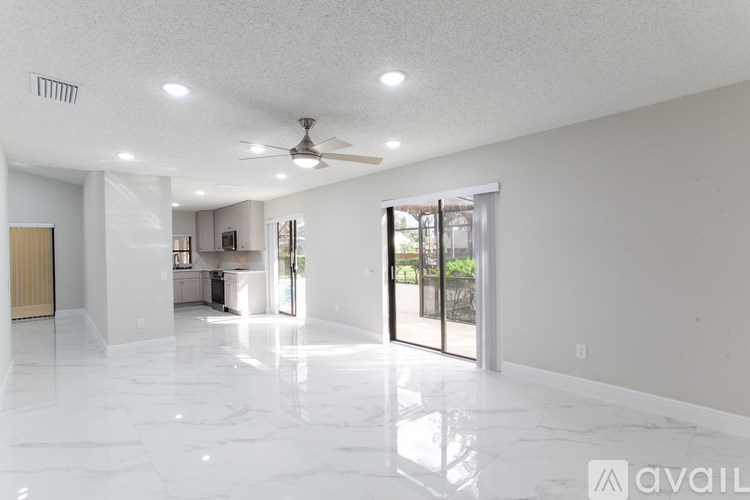 A bathroom with a tub, sink, and mirror.