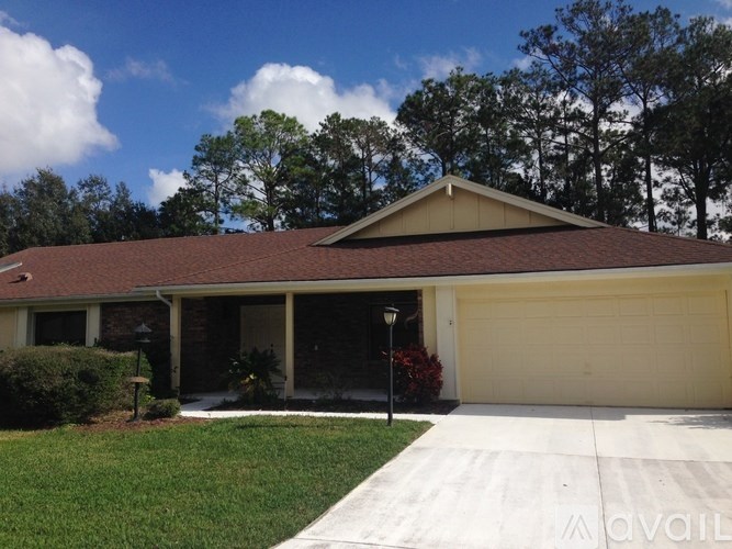 A house with a brown roof and a garage door.