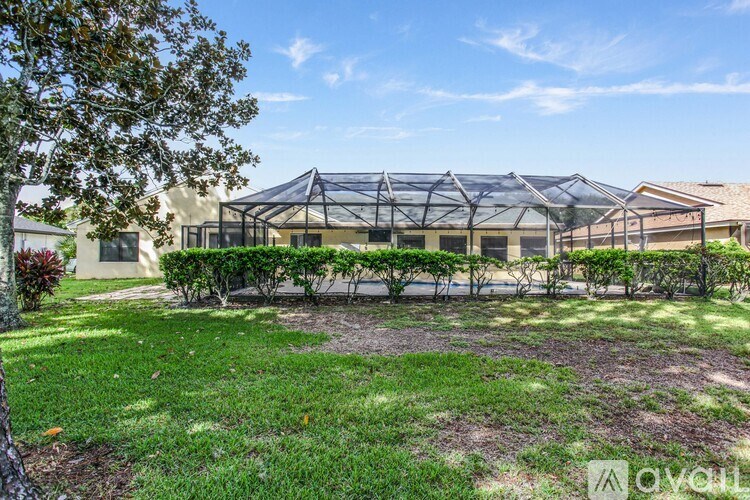 A green lawn in front of a building with a glass roof.