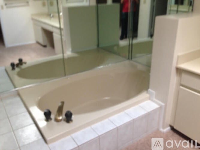 A bathroom with a bathtub and a sink.