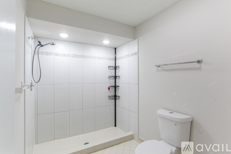 A carpeted room with a wallpapered wall and a plain wall.