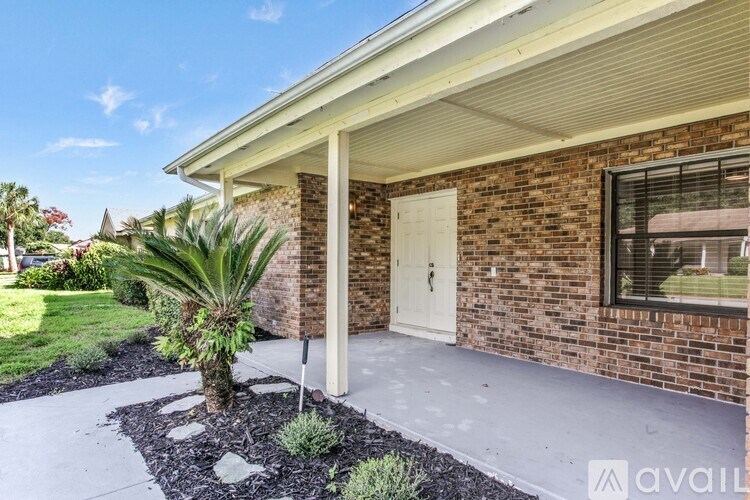 A room with a window covered by brown curtains and a ceiling fan.