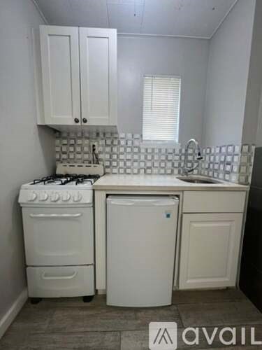 A small kitchen with a white stove and dishwasher.