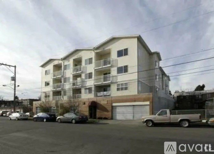 A large apartment building with a parking lot in front of it.