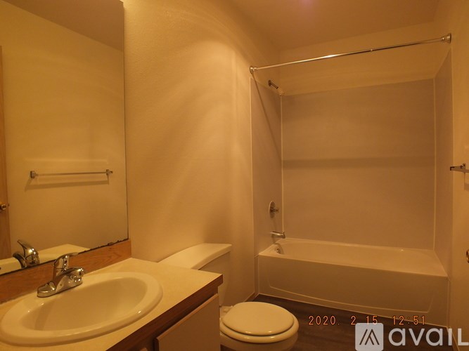 A bathroom with a toilet, sink, and bathtub.