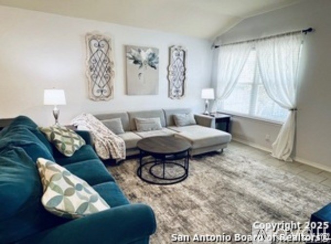 A living room with a green couch and a coffee table.