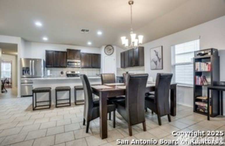 A dining room with a table set for four.