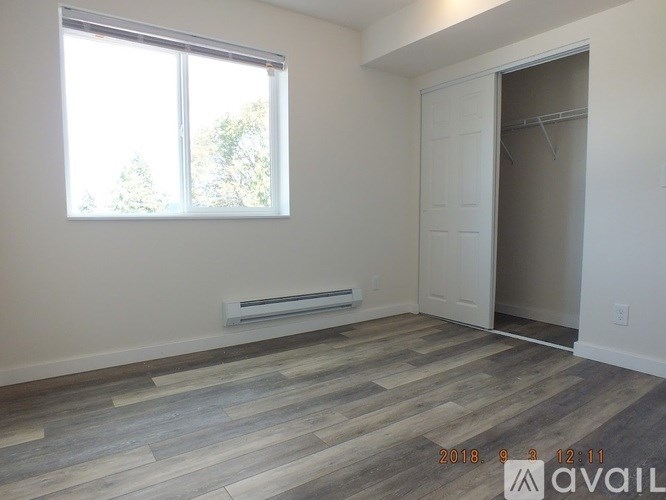 A room with a window and a door is available for rent.