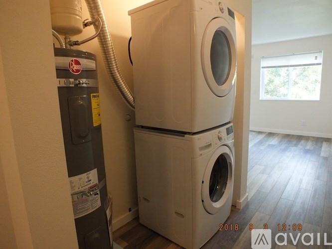 A stack of two white front loading washing machines in a laundry room.