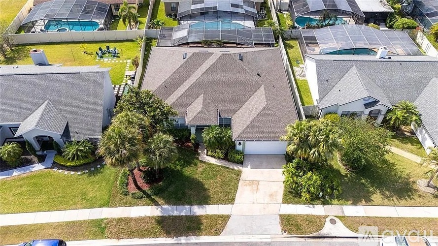 A bird's eye view of a neighborhood with houses and swimming pools.