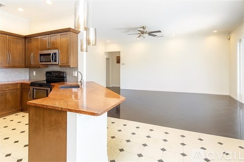 A kitchen with a wooden counter and a black stove top oven.